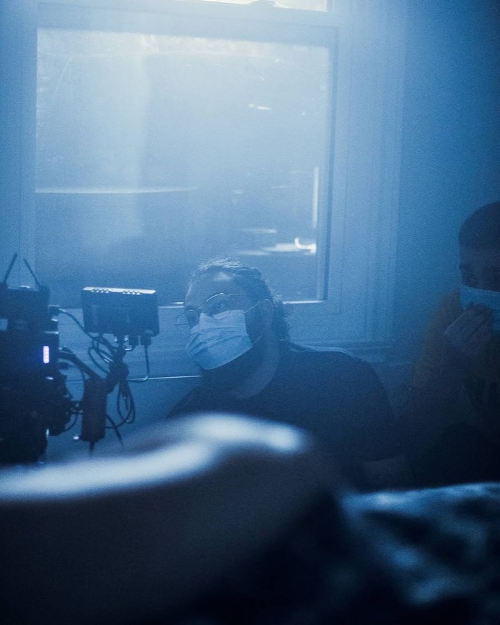 Crew filming in blue atmospheric haze