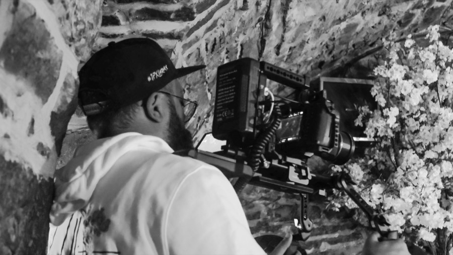 Camera operator shooting through flowers