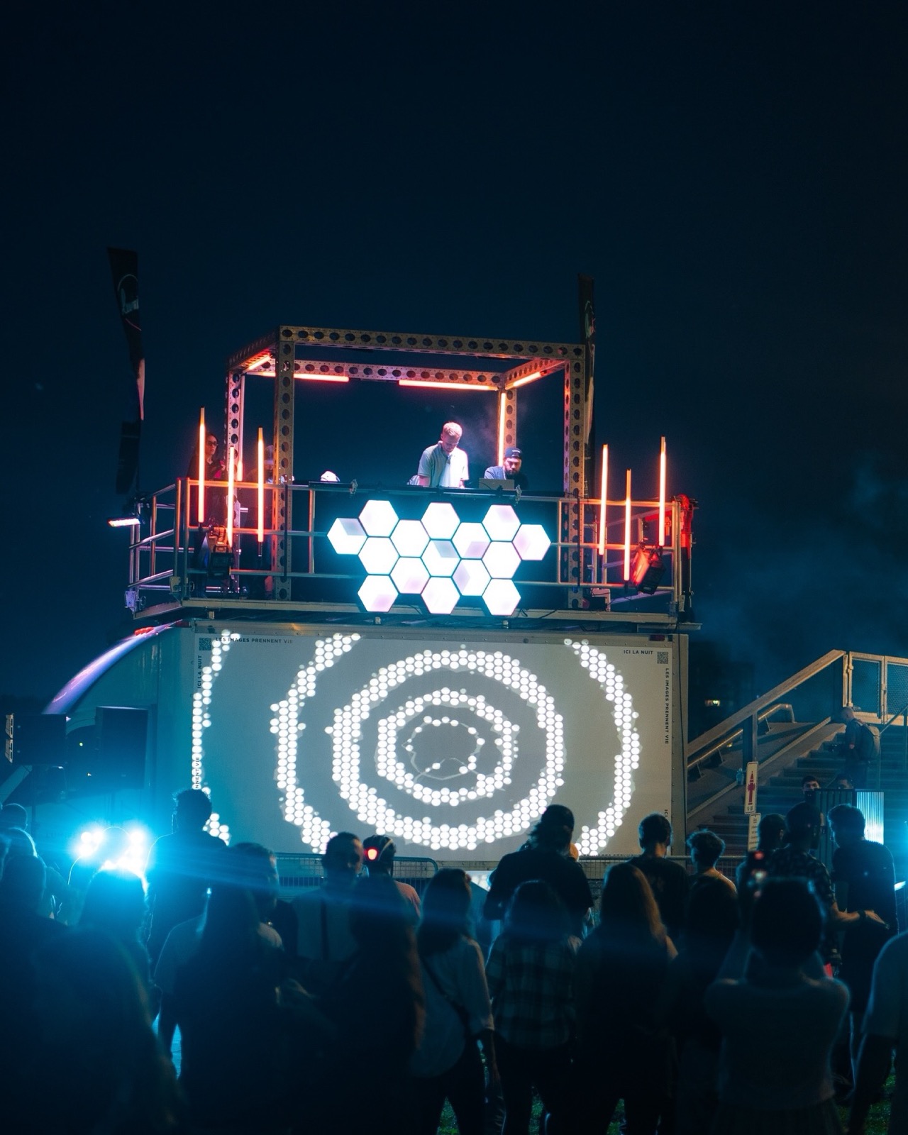 Container stage with LED visuals and a crowd at a 1PXL pop-up event