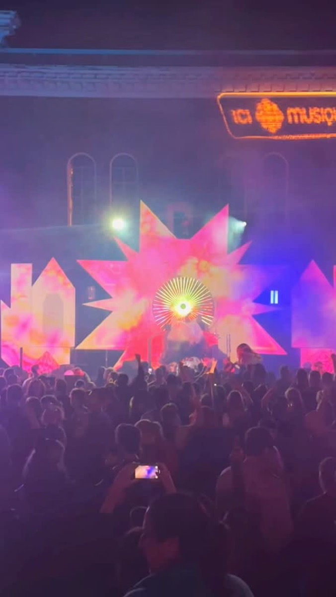 Main stage with projection visuals and crowd at Lumifest