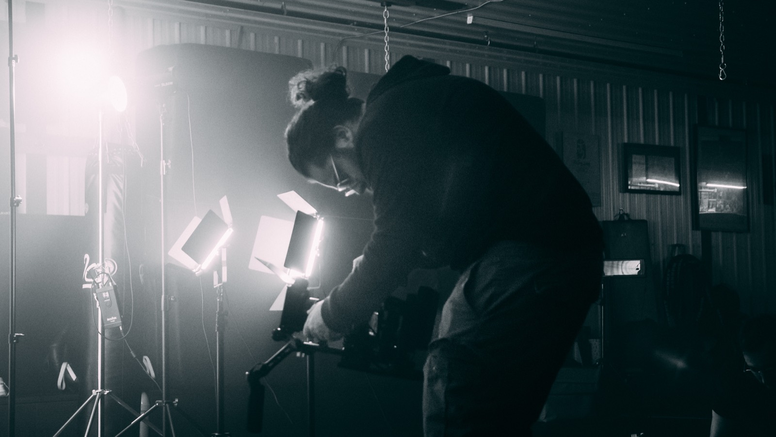 Camera operator working between practical lights